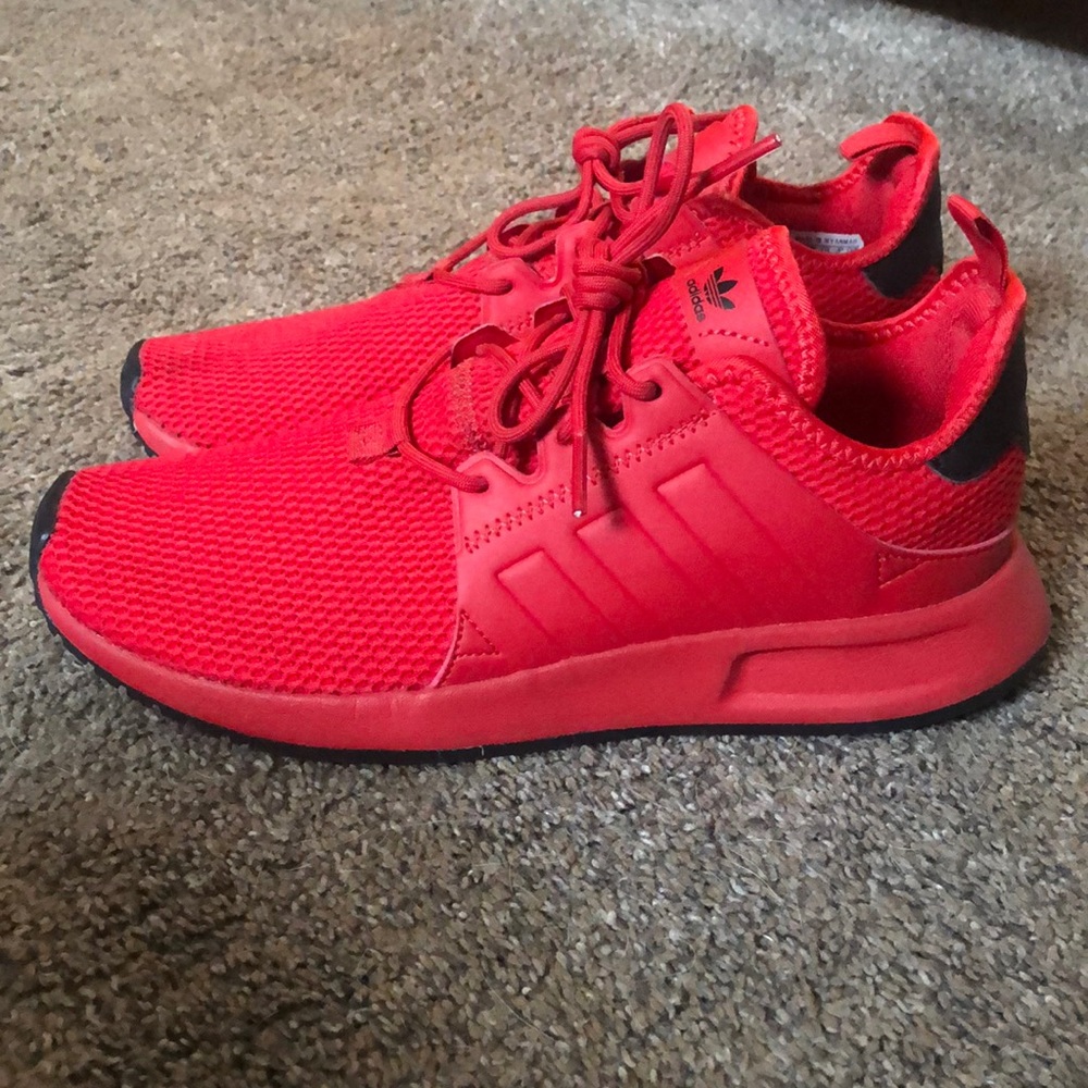 Lightly worn red adidas running shoes.